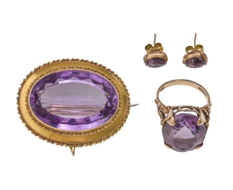 A Victorian amethyst brooch, in gold, 40mm l, 16.7g and an amethyst ring and pair of ear studs, in gold, 8.7g, size M (4)  Th