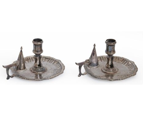 A pair of George III silver chambersticks, with waisted sconce, fluted cavetto and gadrooned rim, 14cm diam, maker's mark rub