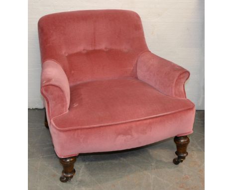 A Victorian mahogany armchair on turned front legs and pottery castors, covered in pink button back fabric, seat height 34cm 