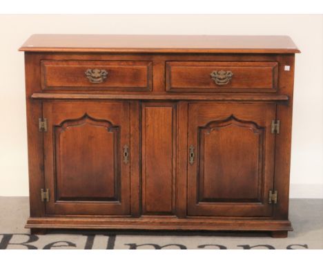 An 18th century style oak side cupboardWith two short drawers over cupboard base, 107cm wide; 76cm high