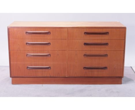 ‘G-PLAN’, a teak chestWith two rows of eight short drawers on plinth base 140cm wide; 72cm high