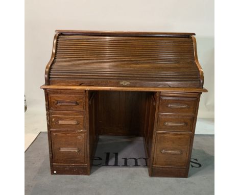An early 20th century oak roll top deskWith six graduated drawers about the knee, 120cm wide; 110cm high