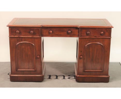 A Victorian mahogany inverted break front pedestal deskThree frieze drawers on over arched cupboard pedestals, 130cm wide; 72