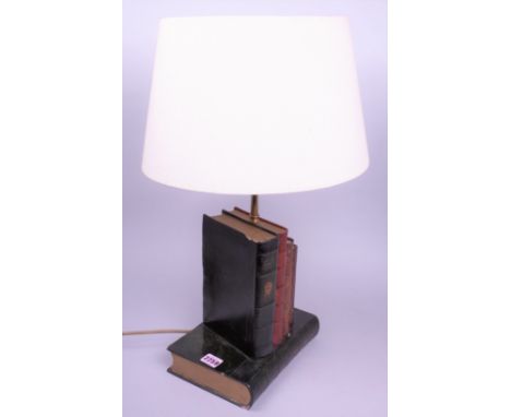 A modern plaster table lamp formed as a stack of books24cm wide; 58cm high