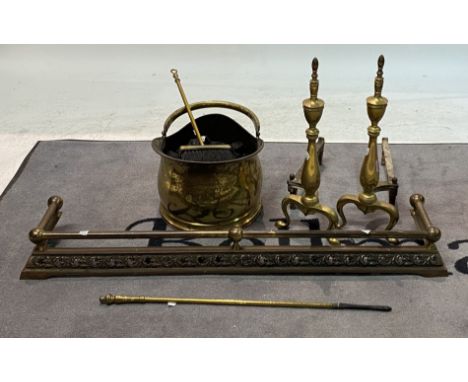A pair of late 19th century brass fire dogs (6)50cm high A brass coal bucket, a later brass fire fender 97cm wide and two fir