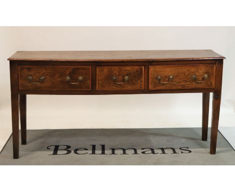 An early 20th century oak and elm sideboardThree frieze drawers on tapering square supports, 175cm wide; 86cm high