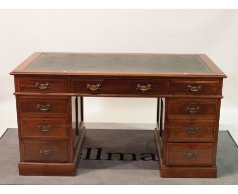 An early 20th century walnut pedestal deskWith nine drawers about the knee on plinth base, 143cm wide; 78cm high