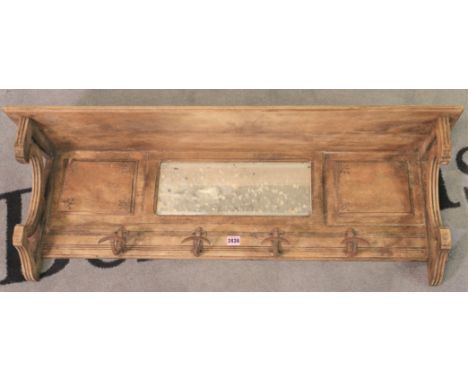 A 20th century walnut hanging coat rackWith integral mirror. 100cm wide 30cm tall.
