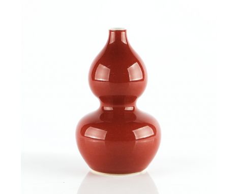 A Chinese flambé vaseblue six character Kangxi mark but later, of double gourd form covered in a deep red glaze, 17.25cm high