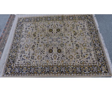 A floral machine made carpet of Persian designLight brown field, 317cm x 241cm