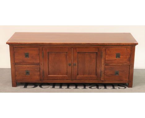 A modern oak low sideboard cupboard doors flanked by four short drawers147cm wide; 55cm high