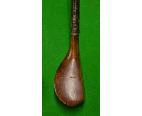 Auchterlonie of St Andrews late transitional brassie in light stained dogwood with a full wrap over brass sole plate^ showing