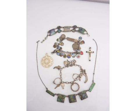 A silver charm bracelet, hung with various shield shaped enamelled souvenir charms, coins, etc; a sterling silver mother-of-p