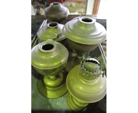 A vintage industrial steel tray containing six various brass lamp bases