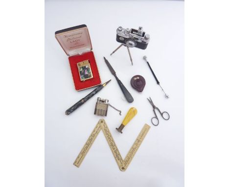 A Lumix table lighter in the form of a miniature camera and tripod, a Kingsway gas lighter with mother-of-pearl panel, a pair