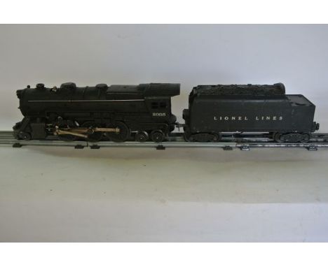 A collection of vintage Lionel electric toy train effects including engine 2035, tank car 6465, hopper car 6456, carboose 625