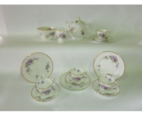 A quantity of early 20th century violet printed tea wares comprising a pair of cake plates, milk jug, slop bowl, twelve tea c