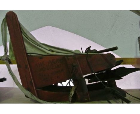 A vintage Aero Broadcast Seed Sower, principally of timber construction with painted red finish and black lettering