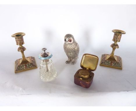 A good quality pair of brass candlesticks raised on squared bases with applied copper work detail depicting male profiles set