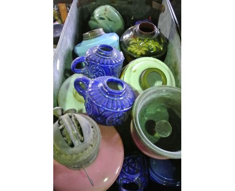 A vintage industrial steel tray containing various glass and ceramic lamp founts, etc