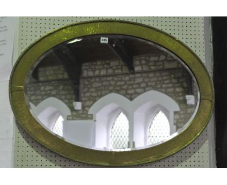 A substantial good quality late 19th/early 20th century wall mirror of oval form with bevelled glass plate, set within a text