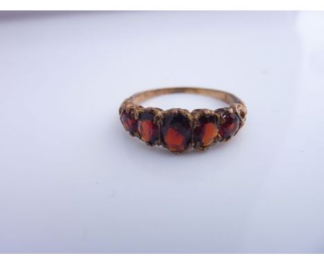 A gem-set Edwardian style ring, set with five graduated orange gemstones, in 9ct gold, size R