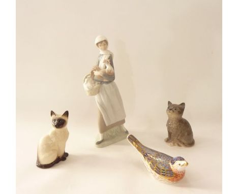 A Lladro Daisa figure of a young woman holding a cockerel with basket of eggs, a Royal Doulton model of a seated Siamese Cat 