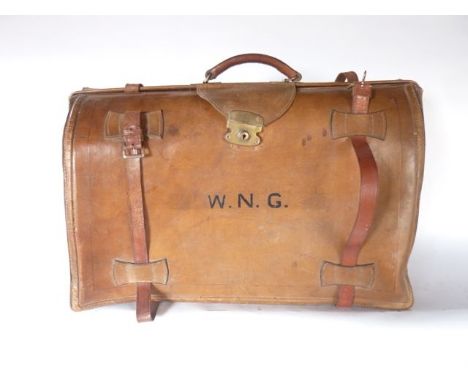 A large vintage stitched tan leather luggage case revealing a cloth lined and divisional interior with further leather straps