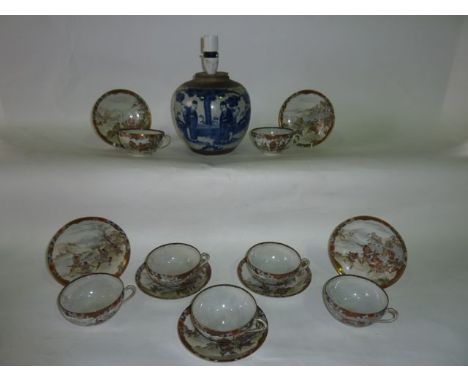 A 19th century oriental blue and white ginger jar base (converted to a lamp) with character decoration in a garden setting to