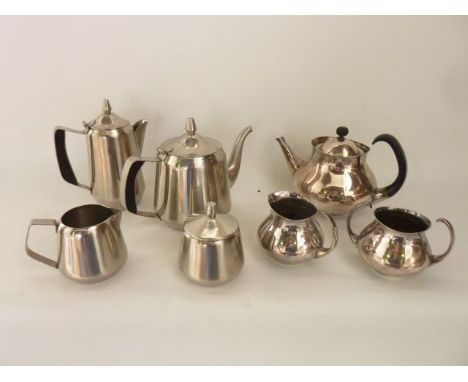 A four piece stainless steel tea set comprising teapot, hot water pot, lidded sugar basin and milk jug, all marked to undersi