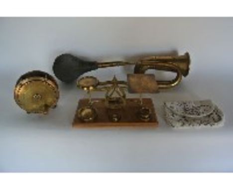 A vintage brass automobile horn stamped Deluxe together with a 19th century brass and copper fishing reel stamped Alex Martin