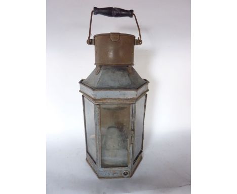 A steel framed wall hanging bulk head lantern with three sided glazed panelled front revealing a fitted burner stamped to ext