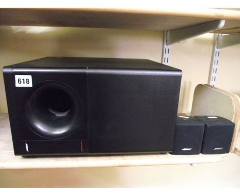 A Bose Acoustimass 3 Series speaker system, the central speaker flanked by a further pair of miniature speakers (3)