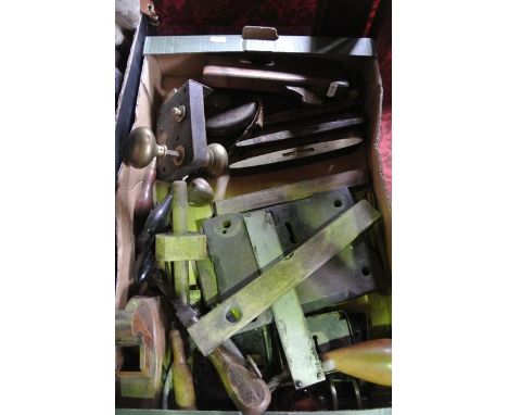 A box containing an assortment of vintage door lock plates, handles, various vintage tools to include a small carpenter's pla