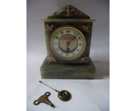 A late 19th century mantle clock in an onyx case with applied gilded detail enclosing an eight day timepiece