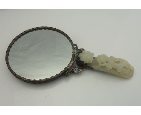 A Chinese silver, enamelled and gem-set hand mirror, 18th/19th century, the mirror verso centred with a white jade plaque, wi