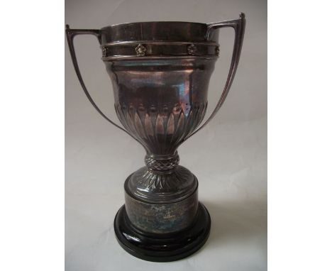 A George V silver trophy cup, William Hutton & Sons Ltd, Sheffield 1928, the shaped body applied with three strap handles, fl