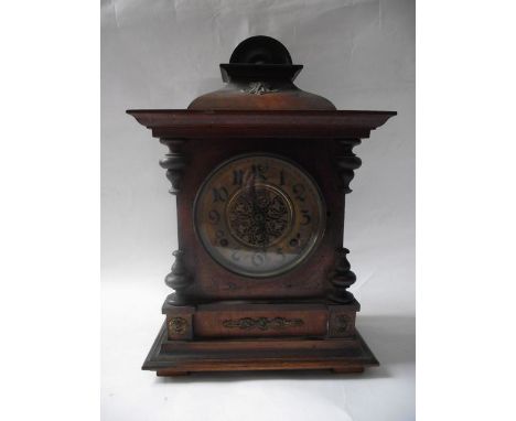 A late 19th century German walnut mantle clock with eight day striking movement, the case with applied and moulded detail