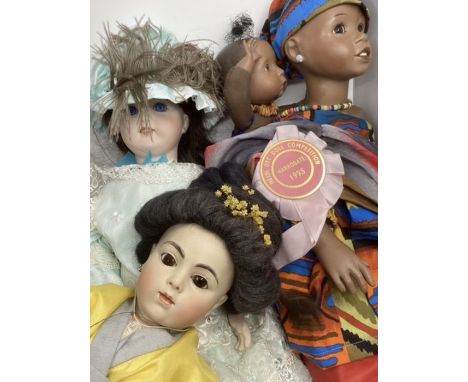 Artist porcelain finely dressed vintage dolls, to include an African lady with her baby in authentic dress and a replica Chin