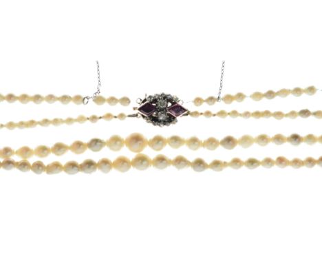 Two row graduated cultured pearl necklace, to a late Victorian ruby and diamond clasp, the sixty-six and sixty-eight baroque 