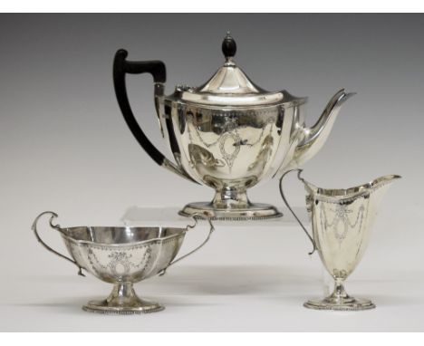 George V silver tea set, each piece having engraved ribbon and swag decoration and standing on an oval foot, makers Mappin & 