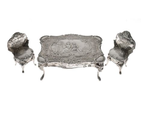Early 20th Century Dutch silver model of a table having typical decoration depicting a romantic couple and scrolling foliage,