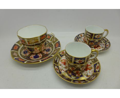 Three Royal Crown Derby cups and saucers; two 2451 coffee cans and saucers and one 1128 tea cup and saucer