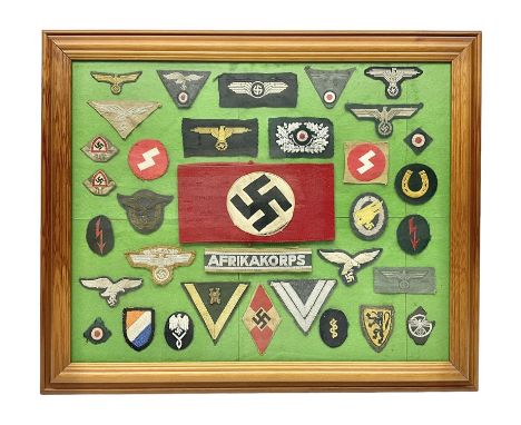 Framed display of thirty-four WWII German cloth badges including Luftwaffe pilot, Paratrooper, Afrikakorps cuff title, sleeve