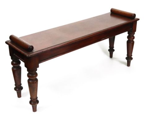 An early Victorian mahogany hall bench, the moulded rectangular seat with roll ends, on turned tapering legs, 106cm wide x 30