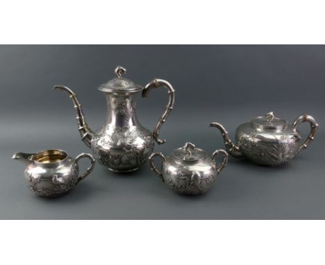 A Chinese export silver four-piece tea and coffee service, Wang Hing & Co, circa 1900, of compressed circular form with faux 
