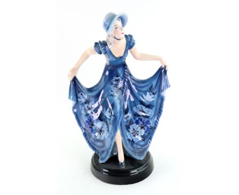 A Goldscheider pottery figure of a young lady, circa 1930, designed by Dakon, gathering up her blue dress painted with flower