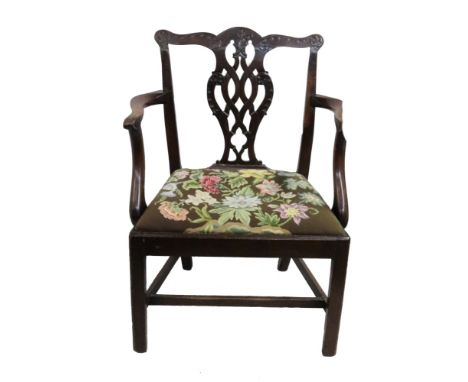 A George III mahogany Chippendale style open arm elbow chair, with foliate carved pierced ribband vase splat back, drop in ne