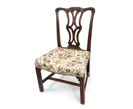 A George III Chippendale style mahogany dining chair, the moulded frame with a leafy scroll carved pierced vase splat, stuff 