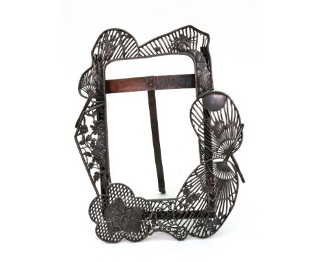 A Japanese easel photograph frame, Meiji, of shaped outline, with four uchiwa (fan) openwork panels variously decorated with 